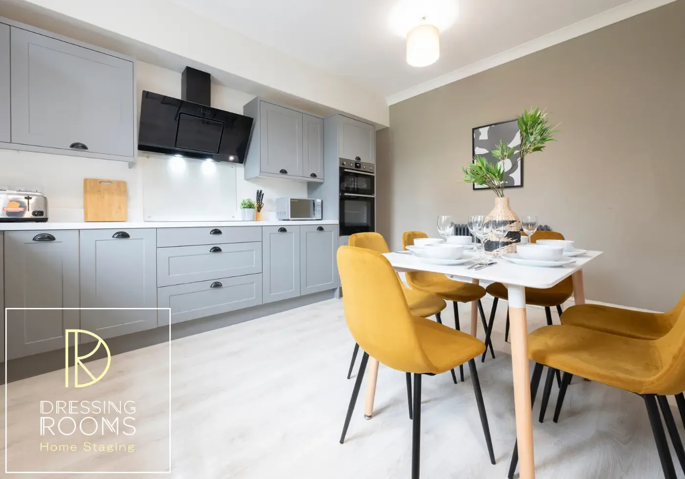 Shared house dining area with yellow chairs