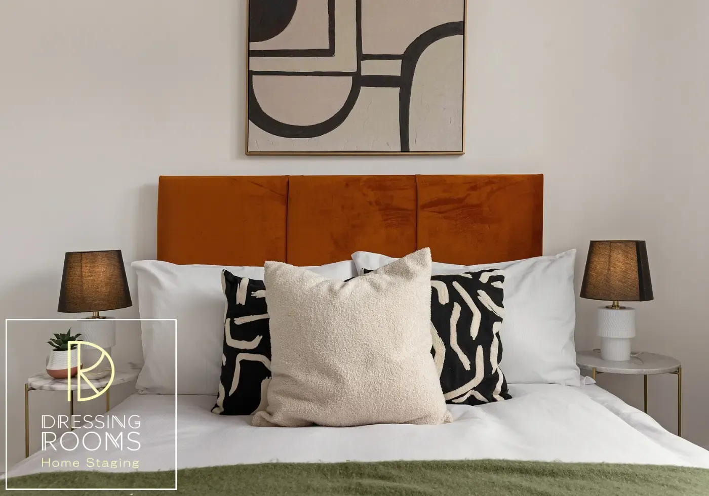 Staged double bedroom with burnt orange headboard