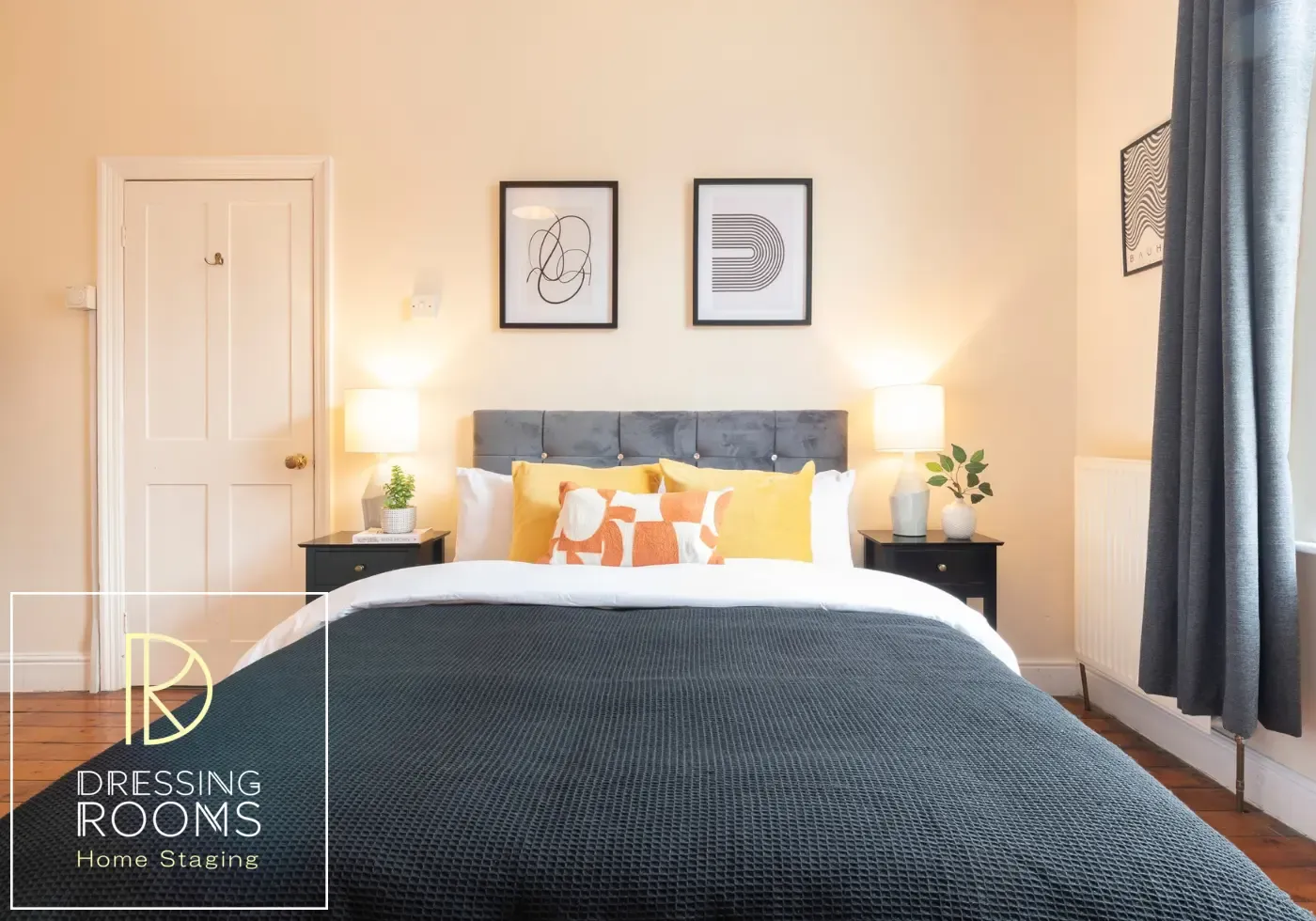 Bright double bedroom styled with orange cushions