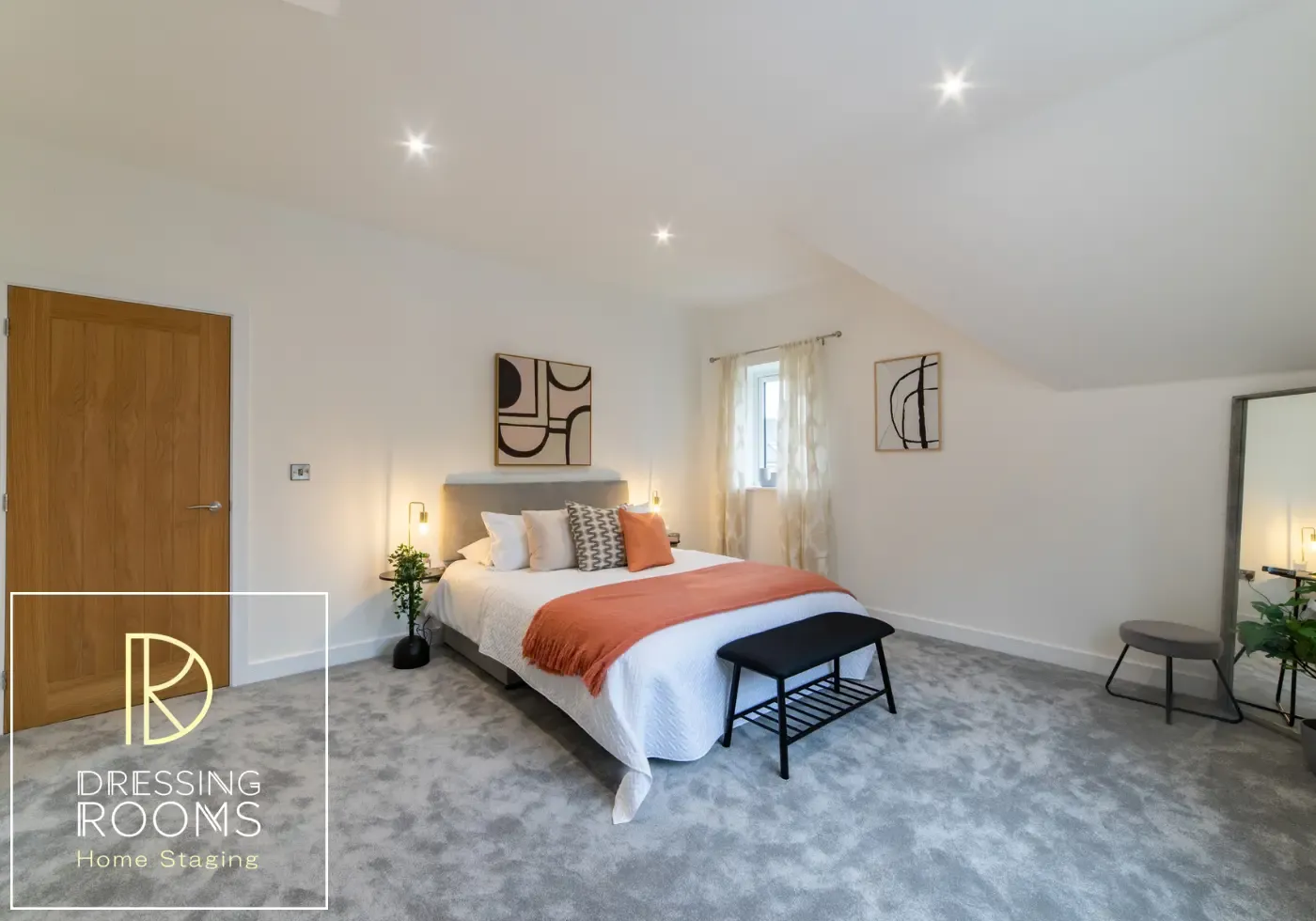 Large staged bedroom with seating and dressing area