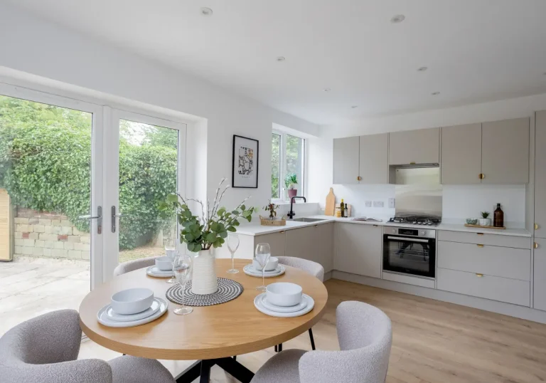 Kitchen dining area with grey kitchen and gold handles