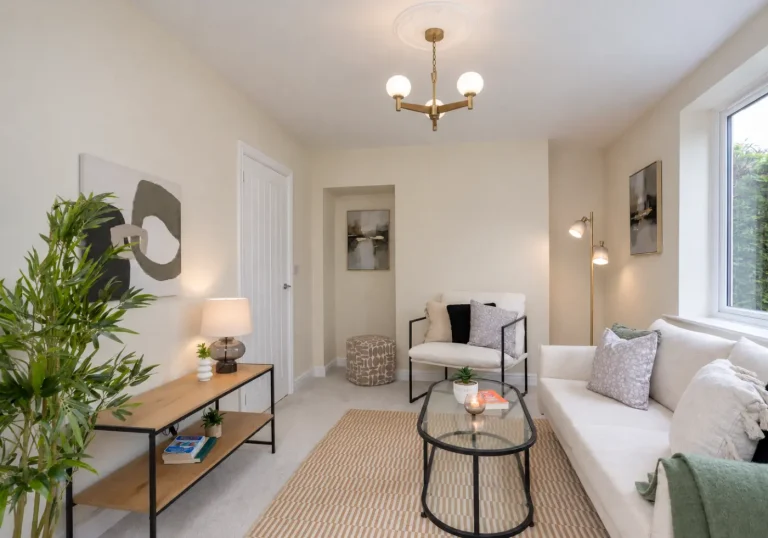 Lounge staged with cream sofas and green plants
